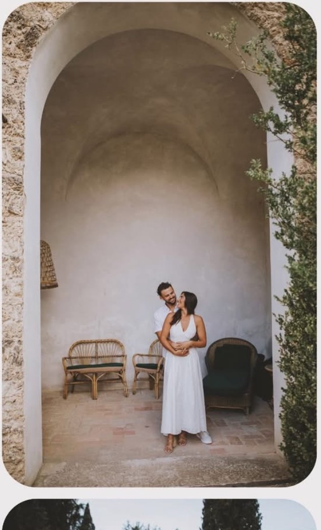 The couple under a stone archway